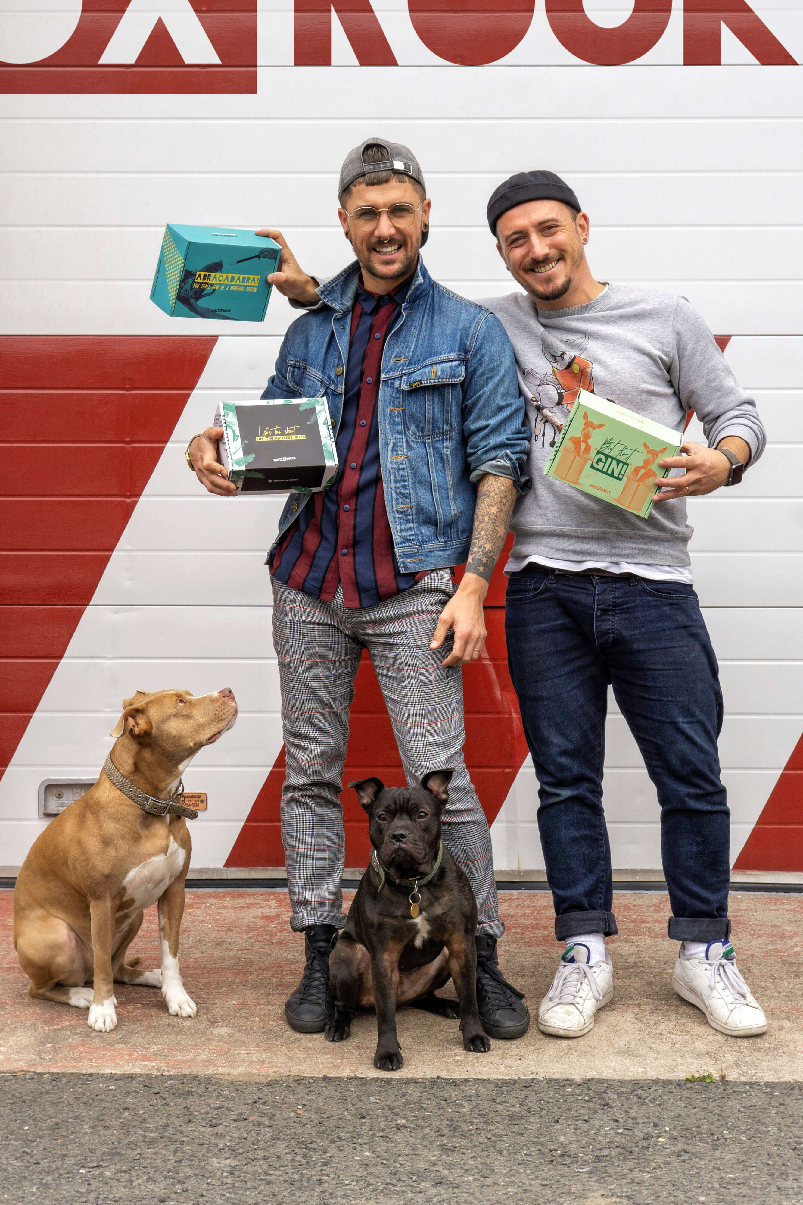 Two guys holding printed cardboard boxes - packhelp