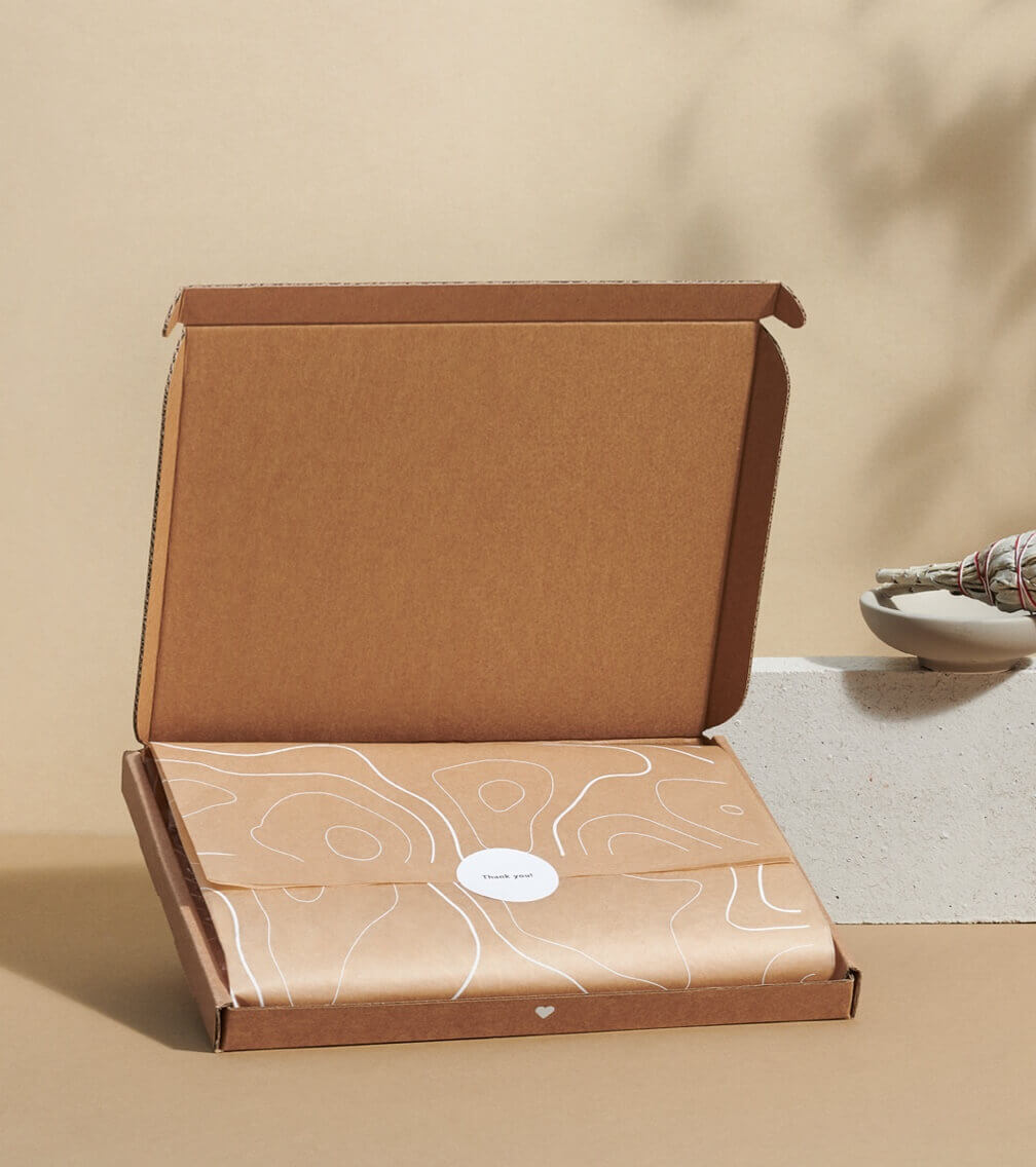item wrapped in kraft packing paper in mailer box